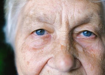 Crop elderly woman with blue eyes